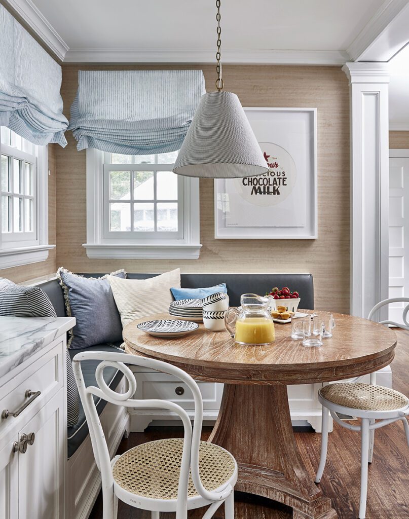 essex county colonial breakfast nook design with custom leather built-in banquette and oak cerused table. family friendly interior design
