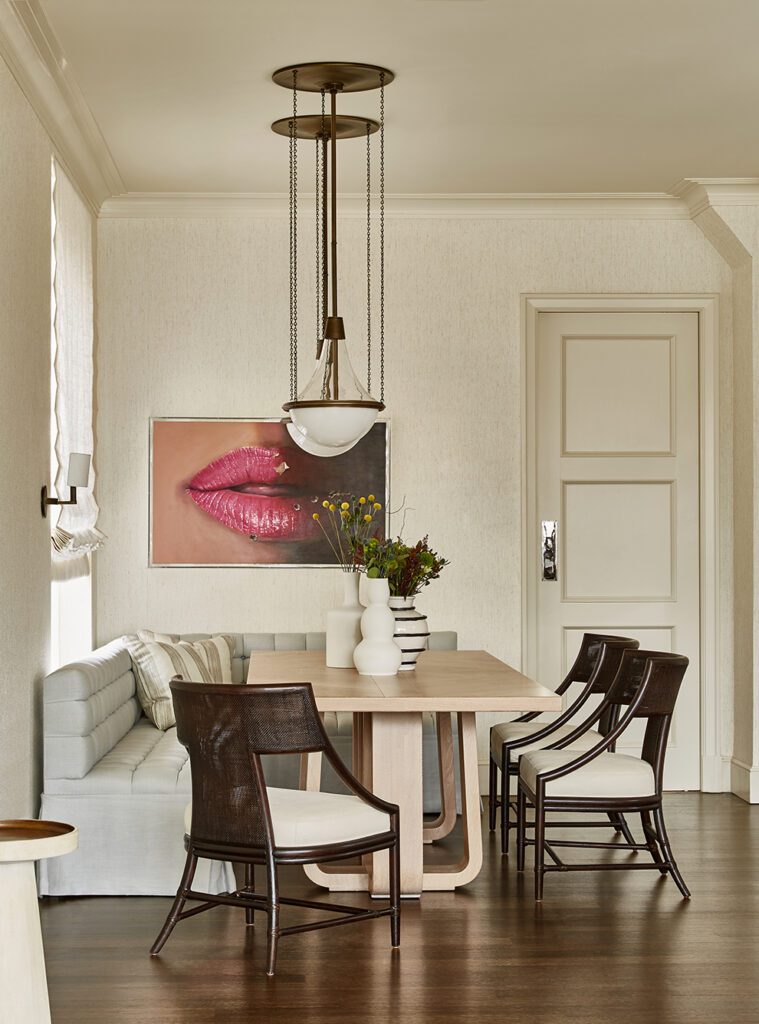 manhattan NYC penthouse apartment home renovation. transitional modern interior design dining room with white oak table, dark wood accents, and custom corner banquette