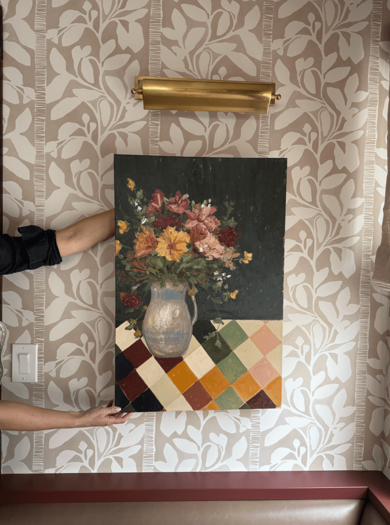 Oxblood cabinetry and patterned wallpaper detail in a Chappaqua townhouse kitchen.
