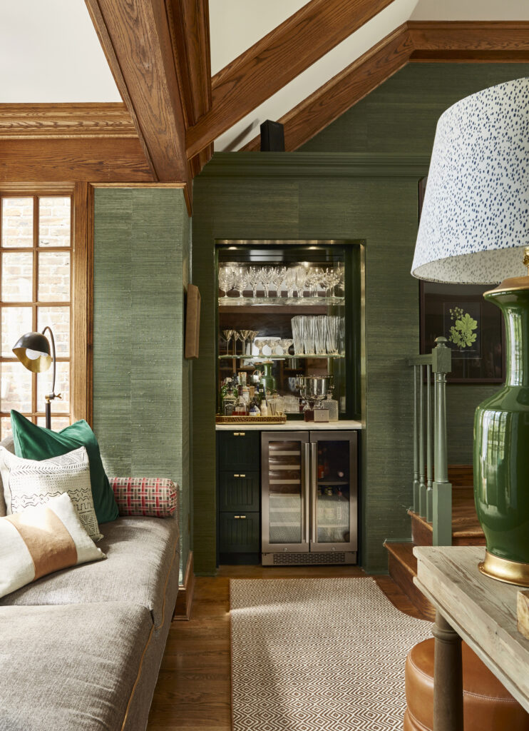 essex fells nj, moody sultry luxurious tudor interior design renovation. green wallpaper and trim, real natural wood accents, leather and brown plaid. family friendly interior design