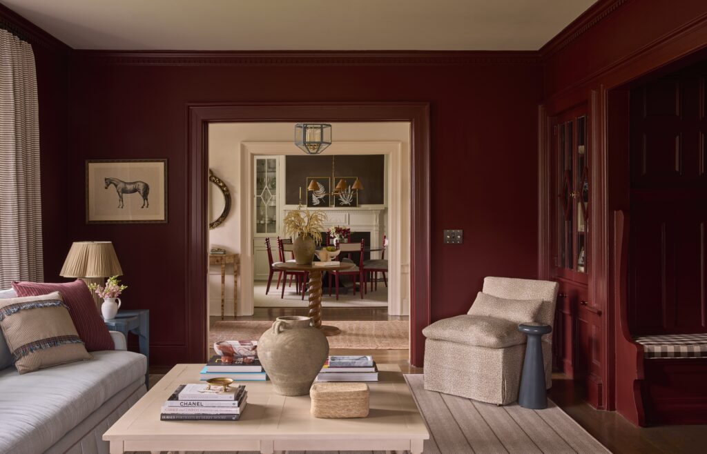 Colonial home in chatham NJ, oxblood red color drenched walls overlooking chocolate dining room